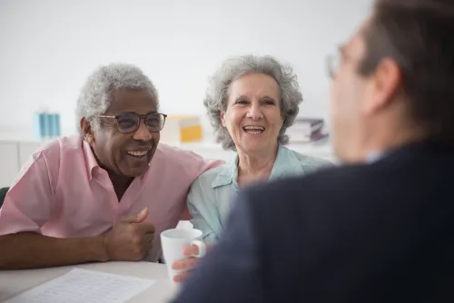 An older couple meets with a professional to discuss future financial and health care planning.